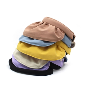 Close-up of colorful foldable sun visors showing multiple layers of breathable fabric
