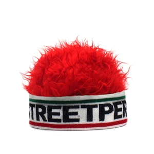 Detail of red faux fur top and knitted headband with STREETPER text logo on beanie
