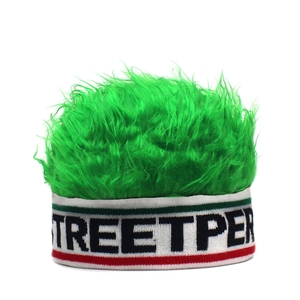 Detail view of the green fuzzy faux hair wig hat with a Streetpe striped knitted headband