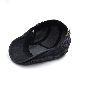 Classic washed blue denim beret hat with contrast yellow stitching and metal buckle