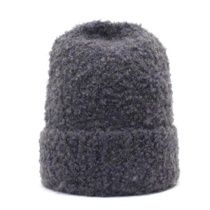 Women's dark grey winter knit beanie featuring thick bouclé texture and cuffed hem