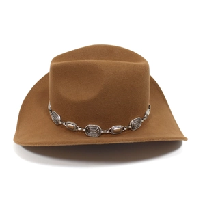 Detailed close-up of brown felt cowboy hat featuring an ornate silver metal decorative chain