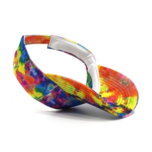 Detail view of colorful tie-dye visor hat with adjustable white hook and loop fastener