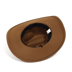 Internal view of brown western cowboy hat showing black sweatband and polyester care label