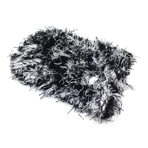 Detailed view of the fluffy black and white knit texture of this winter thermal headband
