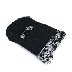 Detailed view of black distressed balaclava featuring white fringed edges and knit texture