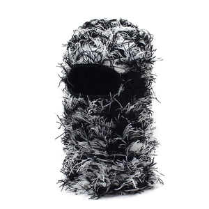 Close-up of distressed black and white knit balaclava with raw fringe textures