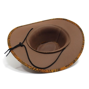 Detail of western cowboy hat brim with animal print edge and adjustable windproof strap