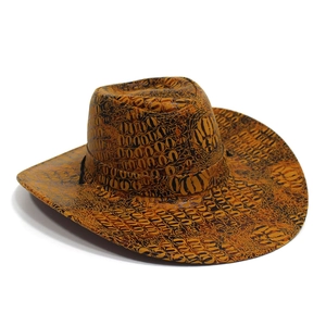 Close-up of orange and black faux crocodile skin texture on a Western cowboy hat