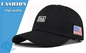 Detail of embroidered USA letters and American flag patch on a black cotton baseball cap