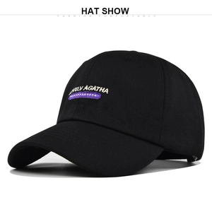Detailed view of white LOVELY AGATHA embroidery and stitching on black baseball cap