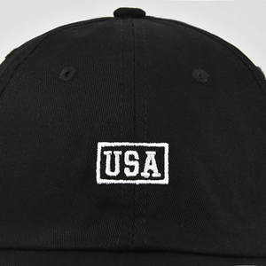 Close-up of high-quality white USA embroidery on black cotton twill baseball cap