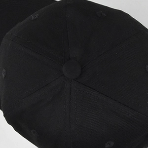 Close-up of black cotton twill baseball cap crown showing stitching and top button detail