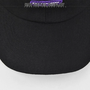 Detail view of cotton twill fabric and precise stitching on a black baseball cap