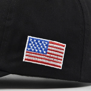 Macro shot of high-quality US flag embroidery on a black cotton twill baseball cap