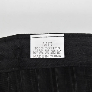 Detail view of cotton baseball cap washing label showing 100% cotton and MD size info