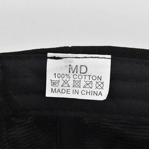 Dettaglio dell'etichetta di lavaggio in 100% cotone e cuciture su un cappellino nero
