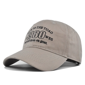 Detailed view of the 1980 black embroidery and stitching on the khaki baseball cap