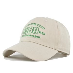 Close-up of green 1980 embroidery detail on a premium beige cotton baseball cap