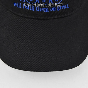 Close-up of blue embroidery on black baseball cap showing stitch detail and fabric texture