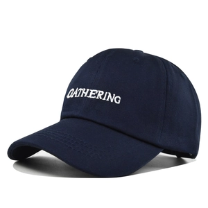 Detail of white gathering embroidery on deep blue cotton twill baseball cap