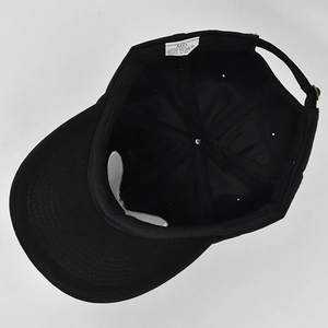 Détail interne de la casquette en coton noir avec étiquette de composition