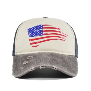 Detail of distressed American flag print and frayed brim on vintage trucker cap