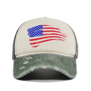 Detail view of distressed USA flag print and frayed brim on a vintage mesh baseball cap