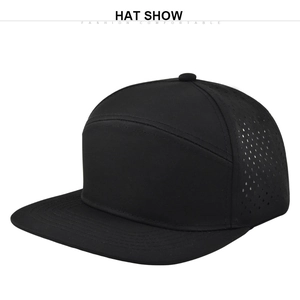 Detail of black flat brim cap with laser-perforated mesh vents for breathability