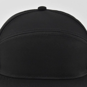 Detailed close-up of a 5-panel black mesh hat showing high-quality fabric texture and stitching