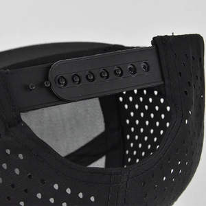 Close-up of black mesh snapback cap featuring adjustable plastic strap and breathable fabric