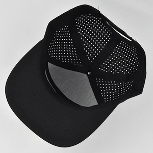 Detail of black snapback cap showing breathable laser cut holes and adjustable strap