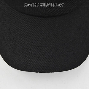 Close-up of black cotton baseball cap brim with multiple rows of reinforced stitching