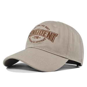 Close-up of khaki baseball cap with CONFIDENT embroidery and premium cotton texture