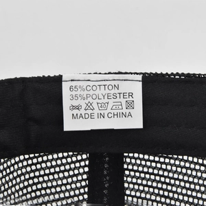 Close-up of internal fabric care label on breathable mesh baseball cap showing 65% cotton