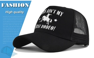 Detail of black trucker hat with white This Ain't My First Rodeo print and mesh back