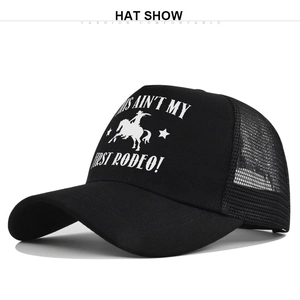 Detail of black mesh trucker hat with white THIS AIN'T MY FIRST RODEO screen printing
