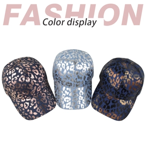 Close-up of vintage metallic leopard print denim baseball caps in three color variations
