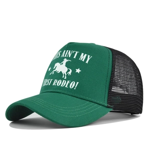 Close-up of green and black trucker hat with mesh back and retro rodeo printing