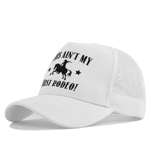 Detail of white trucker hat showing breathable mesh back and Rodeo slogan print