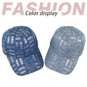 Detail of blue denim baseball hats with holographic QUEEN print and washed finish