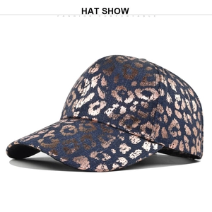 Detailed view of the copper leopard print texture on a navy blue vintage denim baseball cap