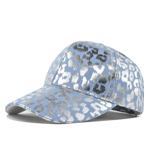 Vintage washed light blue denim baseball cap with metallic silver leopard print design