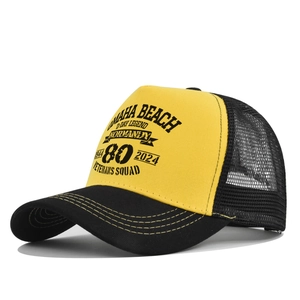 Detail of yellow trucker hat with D-Day Legend Omaha Beach printing and mesh back
