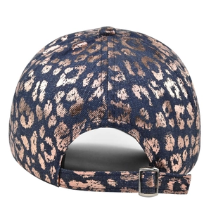 Detail of adjustable metal buckle and metallic leopard print on washed denim baseball cap