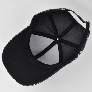 Detail view of denim baseball cap interior with black lining and adjustable metal buckle