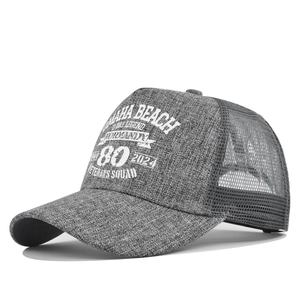 Detail showing Omaha Beach Normandy embroidery on grey mesh back trucker hat