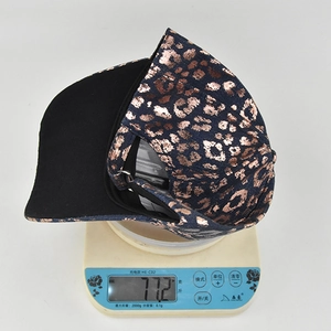 Detailed shot of a leopard print denim baseball cap on a scale weighing 77.2g