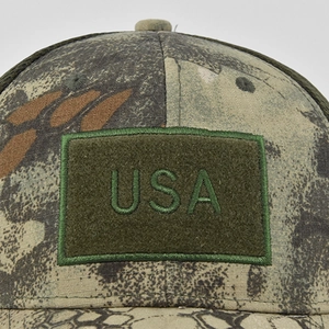 Macro detail of USA embroidery on camouflage tactical baseball cap with durable fabric