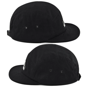 Detail view of black five-panel ripstop cap showing side metal eyelets and adjustable strap